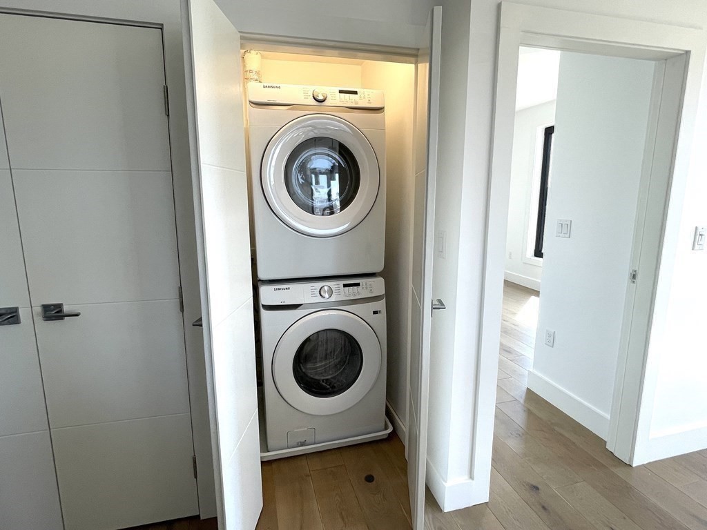 30 Penniman Road, Unit 507 Boston, MA 02134 - Photo 9 of 22 a view of a hallway with washer and dryer