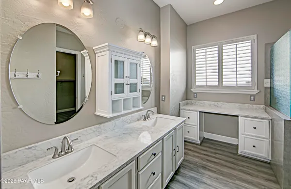 a spacious bathroom with double vanity and a mirror