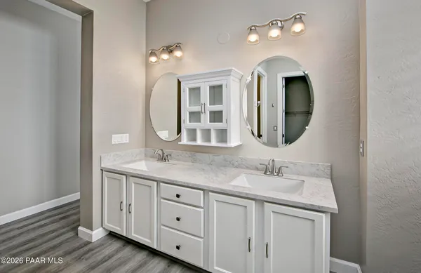 a bathroom with a double vanity sink and a mirror