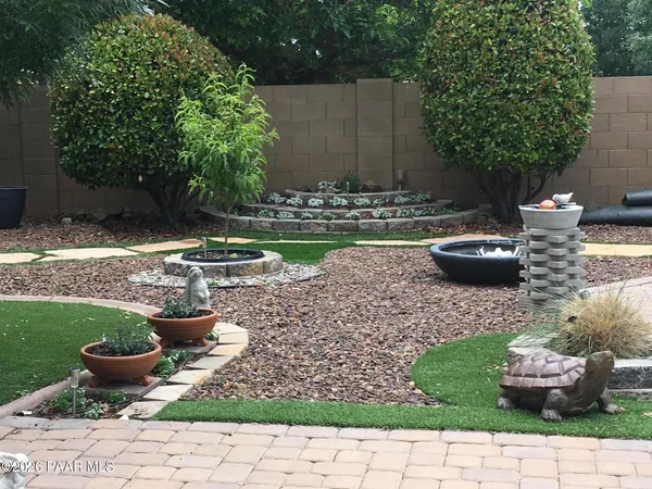 a view of a backyard with plants and patio
