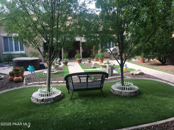 a backyard of a house with table and chairs