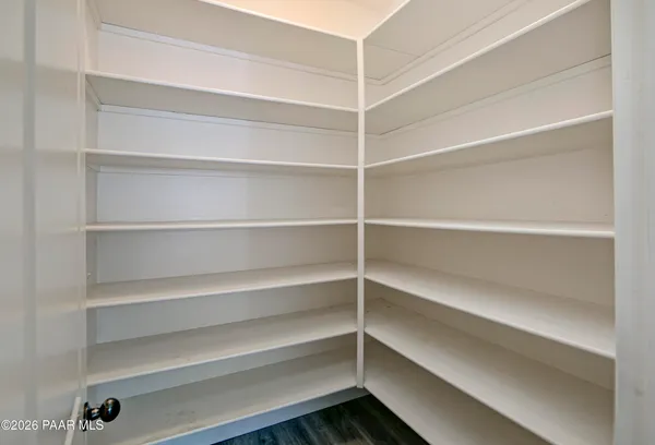 a view of walk in closet with empty racks