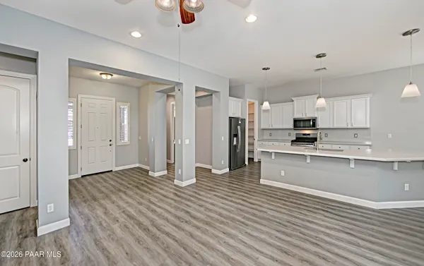 a large kitchen with stainless steel appliances granite countertop a refrigerator and a sink