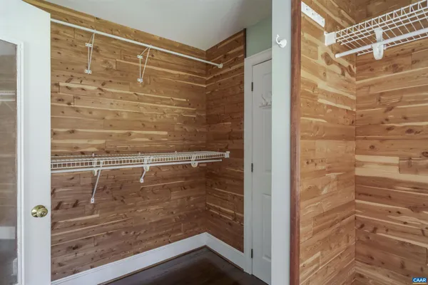 a view of a house with backyard and trees