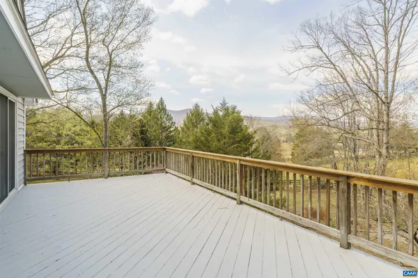 a view of a yard with wooden fence