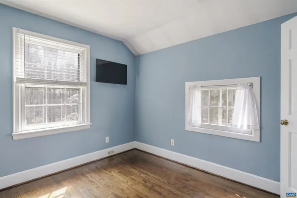 a view of a house with a yard covered in snow