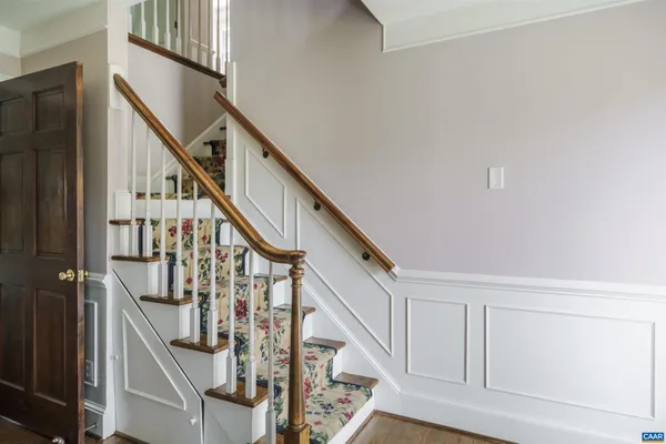 a kitchen with stainless steel appliances a sink stove and wooden floor