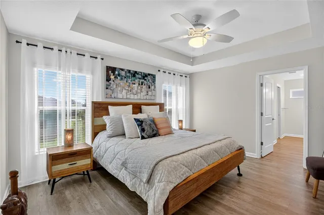 a bedroom with a bed and a chandelier