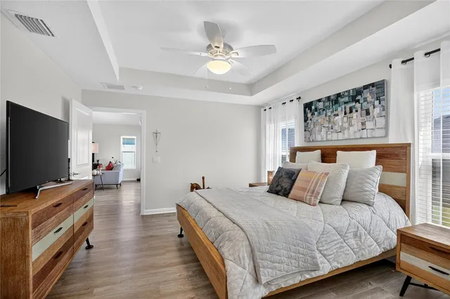 a bedroom with a bed and a flat screen tv