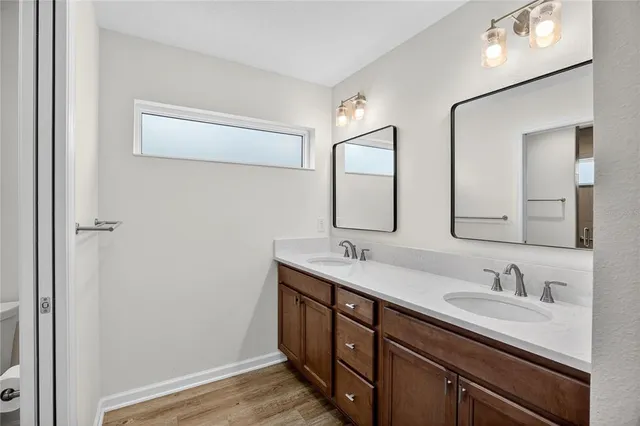 a bathroom with a double vanity sink and a mirror