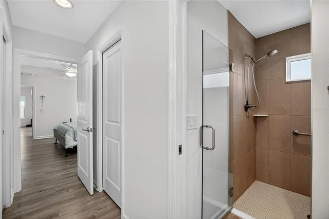 a bathroom with a sink and glass door shower