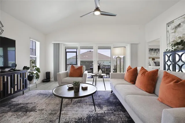 a living room with furniture a rug and a large window