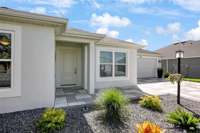 a house with potted plants in front of it