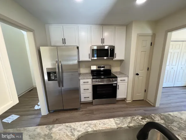 a kitchen with stainless steel appliances a refrigerator stove and sink