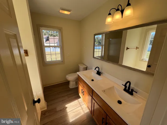 a bathroom with a tub sink and mirror