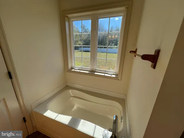 a bath tub sitting next to a window