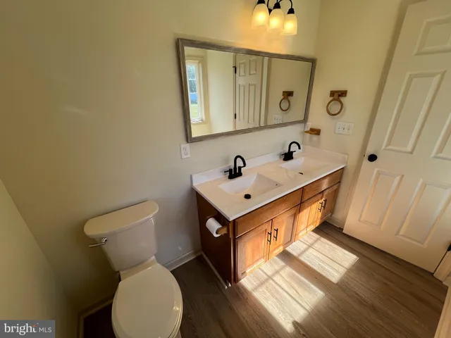 a bathroom with a toilet sink and mirror
