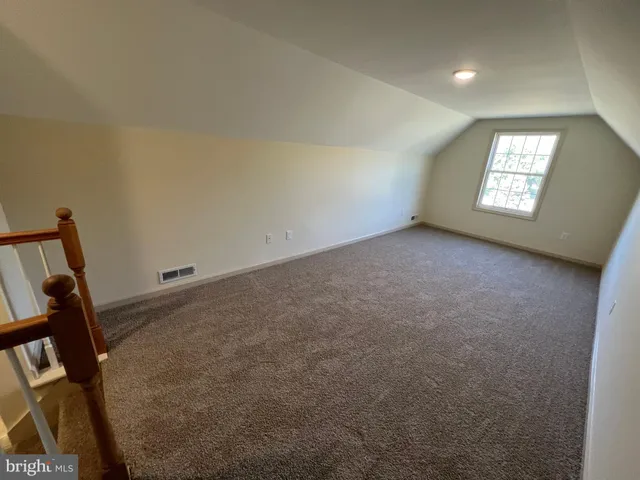 a view of an empty room and a window