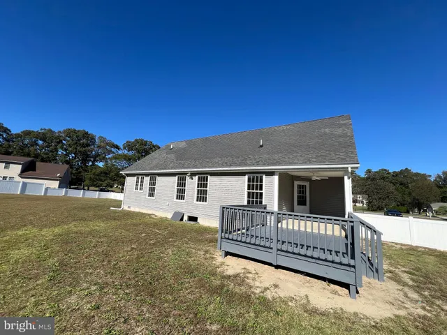a view of a house with wooden fence