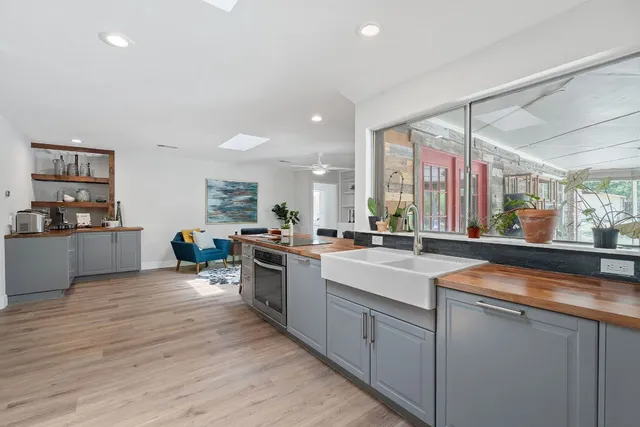 a kitchen with sink cabinets and wooden floor
