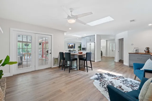 a living room with furniture and wooden floor