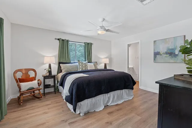 a bedroom with a bed and a chandelier