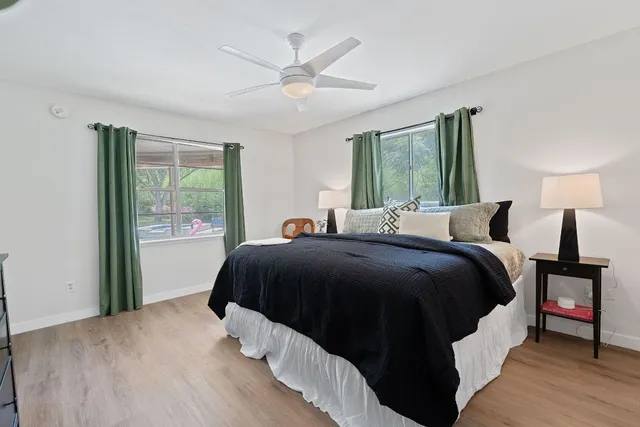 a bedroom with a large bed and a large window