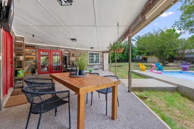 a view of a dining room with furniture and a floor to ceiling window