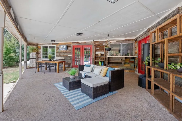 a living room with lots of furniture and a chandelier