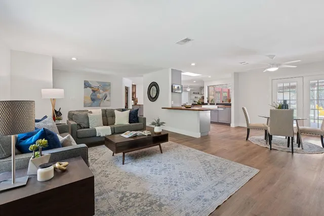 a living room with furniture and kitchen view