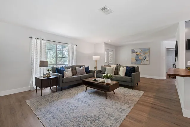a living room with furniture or couch and a wooden floor