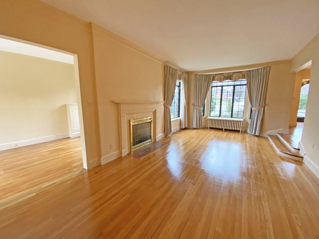 3 Exmoor Road Newton, MA 02459 - Photo 15 of 41 a view of a livingroom with wooden floor and a fireplace