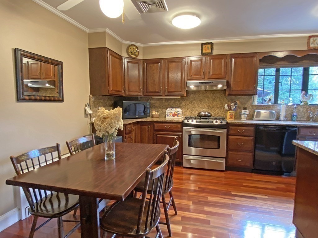 3 Exmoor Road Newton, MA 02459 - Photo 23 of 41 a kitchen with a stove a table and chairs