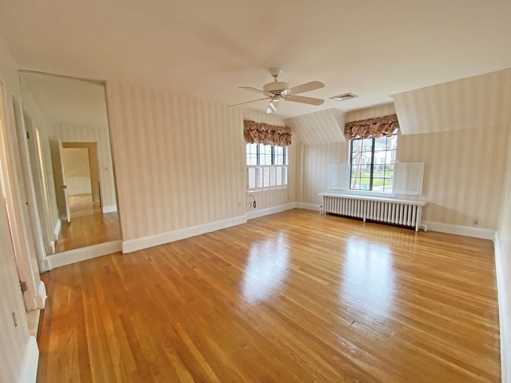 3 Exmoor Road Newton, MA 02459 - Photo 30 of 41 a view of an empty room with window and wooden floor