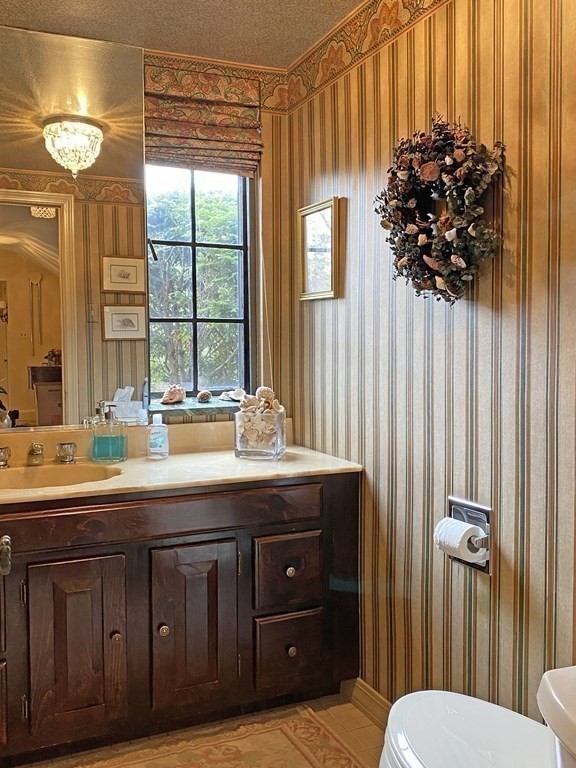 3 Exmoor Road Newton, MA 02459 - Photo 33 of 41 a bathroom with a sink a mirror and a shower curtain