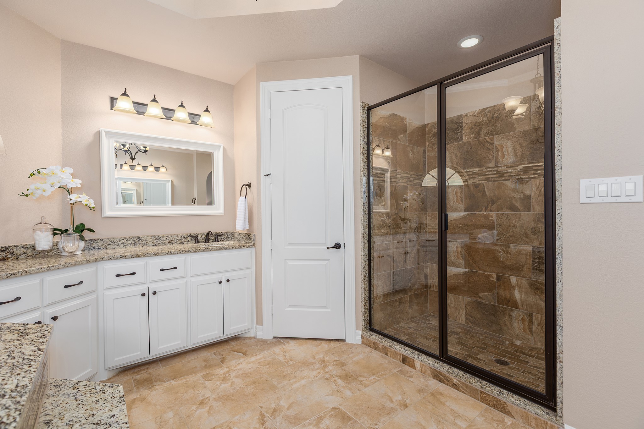 27688 Rio Blanco Drive Splendora, TX 77372 - Photo 26 of 50 a bathroom with a granite countertop sink a mirror and shower
