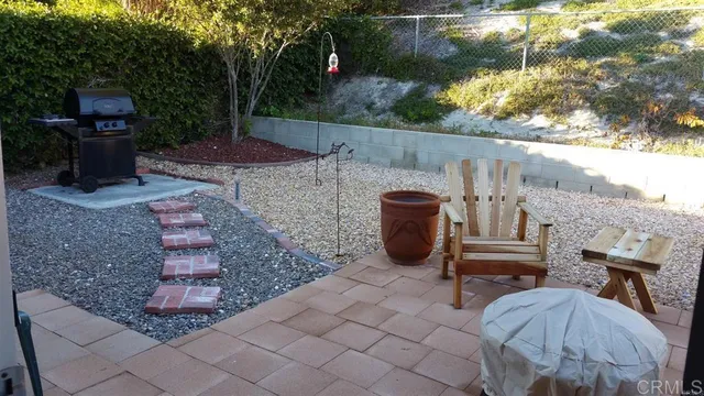 a view of an outdoor sitting area with brick walls