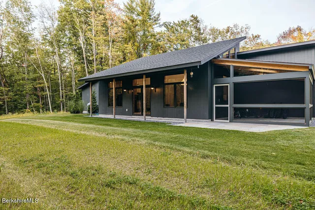 a view of an house with backyard space and balcony