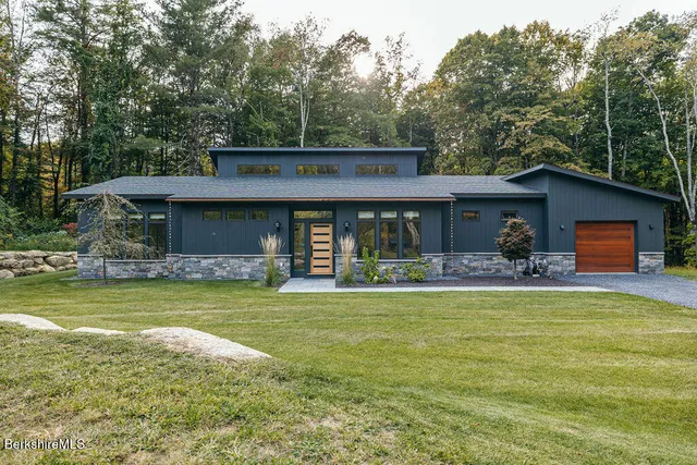 a front view of a house with a garden