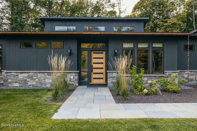 a front view of a house with garden