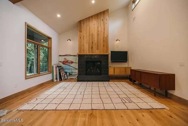 a living room with a fireplace furniture a desk and chair