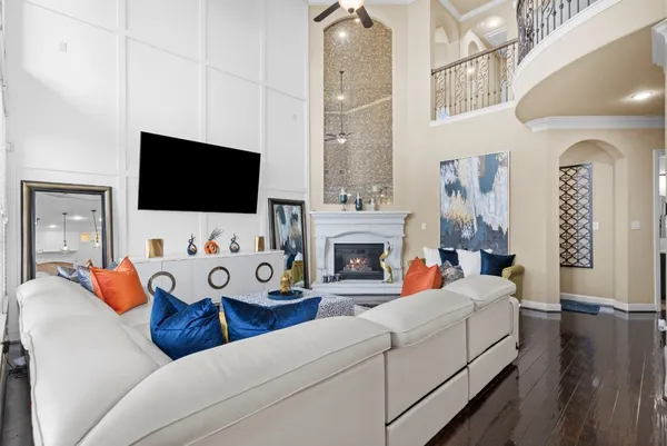 a living room with furniture a flat screen tv and a fireplace