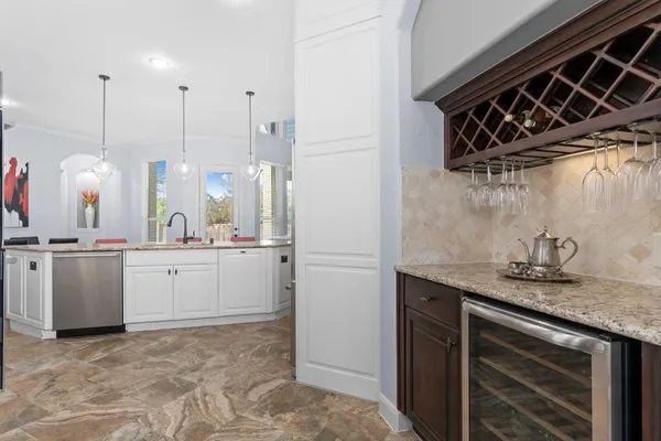 a kitchen with stainless steel appliances granite countertop a kitchen island a stove a sink a dining table and chairs