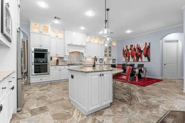 a large white kitchen with lots of appliances
