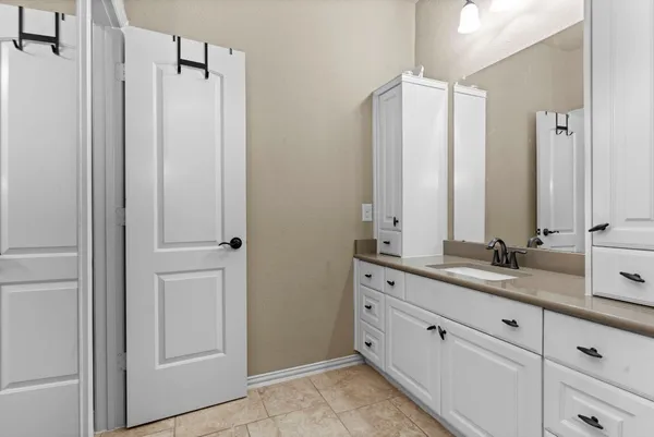a bathroom with a double vanity sink and a mirror
