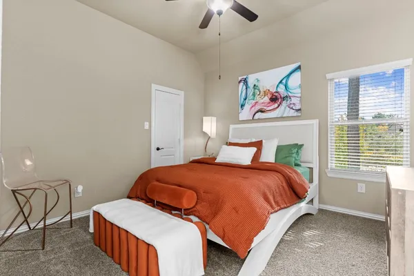 a bedroom with a bed and window