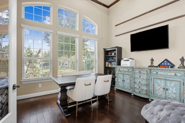 a view of a livingroom with furniture a flat screen tv and a floor to ceiling window