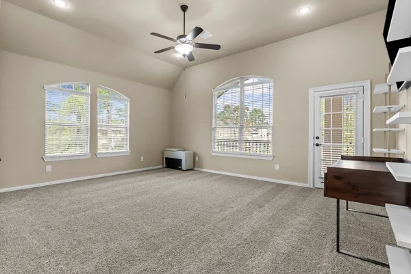 a bedroom with a bed and a ceiling fan