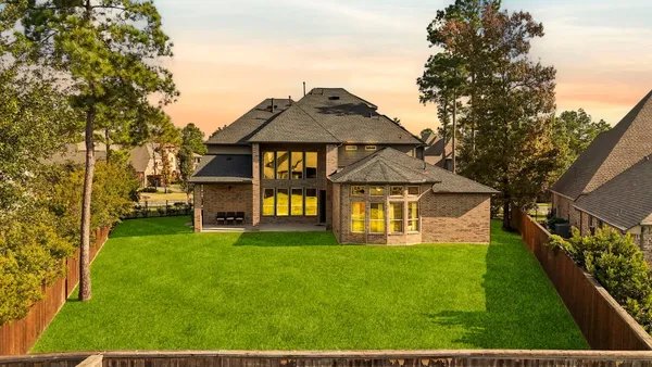 an aerial view of a house with a big yard