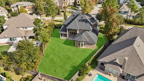 an aerial view of a residential apartment building with a yard